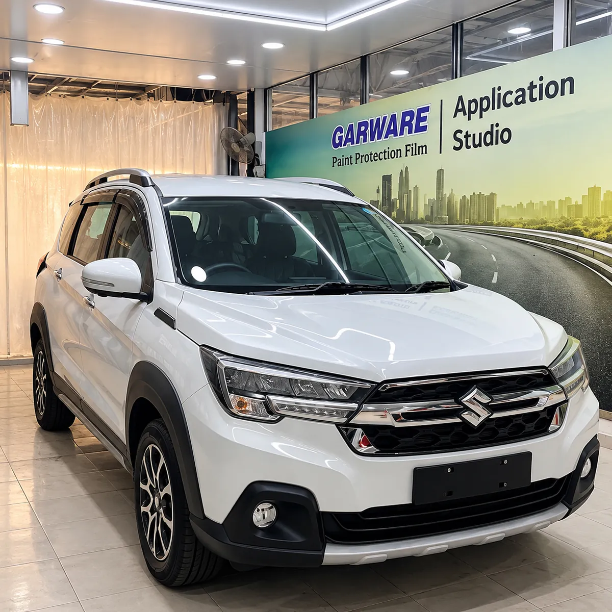 White Maruti Suzuki XL6 at the Garware Paint Protection Film application studio, Kar Care Yelahanka